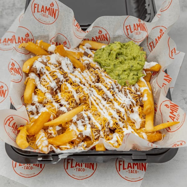 El Flamin Taco's loaded fries with shredded cheese, ground beef, sour cream, and guacamole.